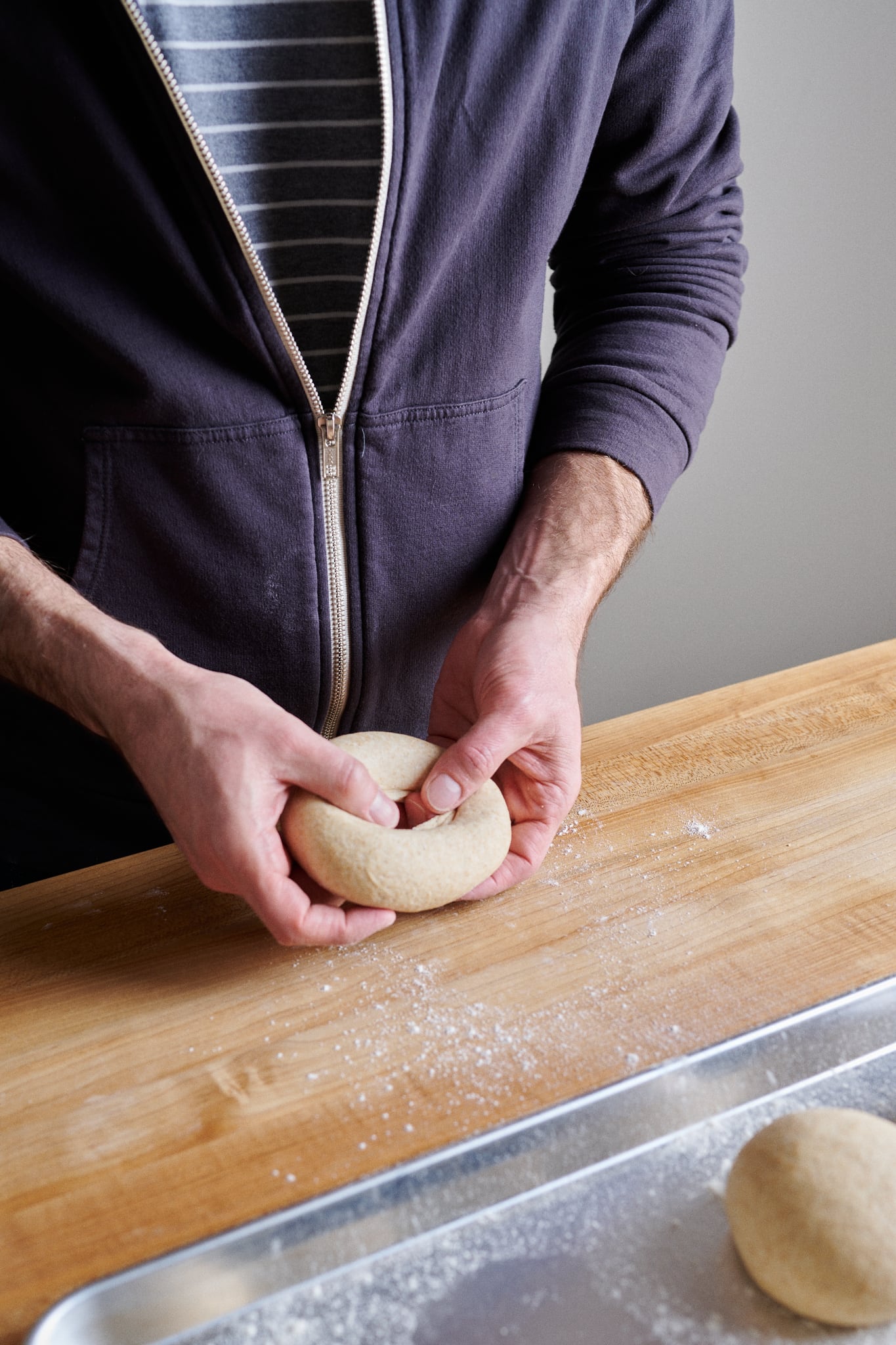 Creating a larger hole in the sourdough friselle dough.
