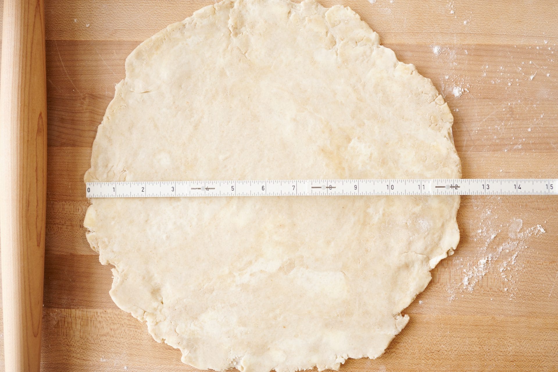 Rolling sourdough pie crust out to 12 inches.